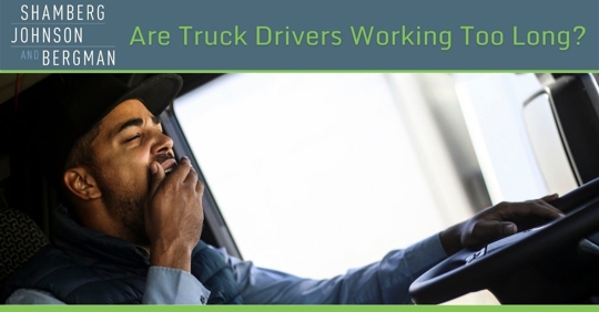 Truck driver yawning with hand to mouth