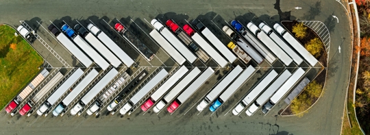 overhead view of trucks parked at truck stop