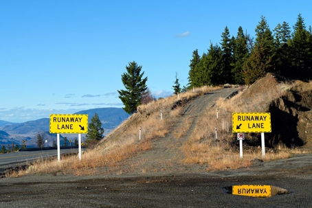 Runaway truck lane with pine trees behind